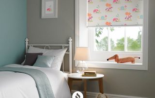 Roller blind with colorful pattern in child's bedroom