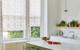 White roller blinds with blue, red and green circles