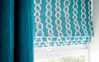 Blue roman blinds with white circle patterns