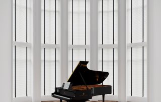 Venetian blinds behind a piano