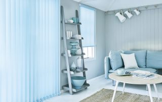 Light blue vertical blinds in matching room