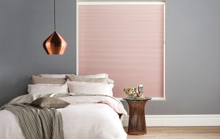 Red and white Duette blinds in bedroom